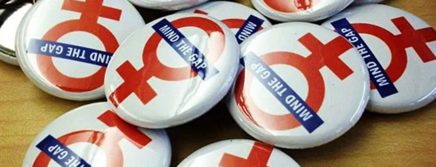 photo of buttons with "mind the gap" written over the female sign